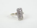 a close up of a diamond ring on a white surface