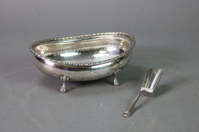 a silver plate with a spoon and fork on the table