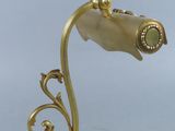 brass plated desk lamp with a glass shade and a gold metal base