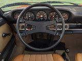 a steering wheel and dashboard of a car in a field