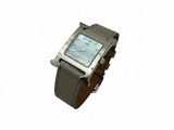 a silver watch with a brown leather band on a white background