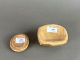 two small wooden bowls sitting next to each other on top of a table