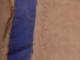 a brown paper bag with a blue stripe on it