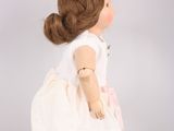 an image of a doll of a little girl in a white dress