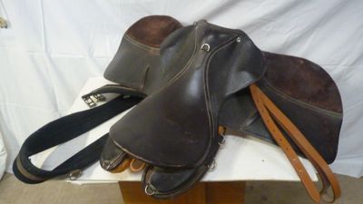 two saddles that are sitting on top of a table