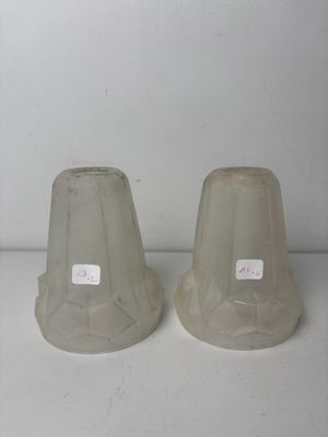 two vases that are sitting on a white table