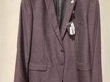 the jacket is purple and has a white tag on it
