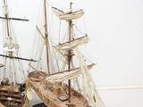two model ships that are sitting side by side on a table