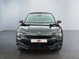 the front view of a black car in a white room