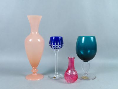 three different colored glass vases sitting next to each other