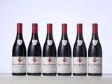 six bottles of red wine lined up in a row