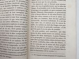 an open book on a table with a white background
