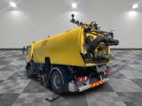 a yellow truck that is sitting on a checkered floor