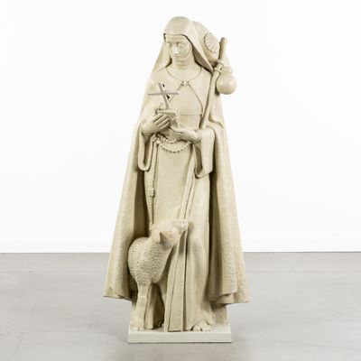 the statue of a woman with a sheep is standing in a white room