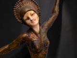 statue of a woman in a body painted with gold and black paint