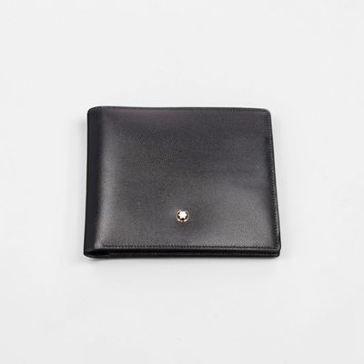 a black leather wallet with a gold button on the front