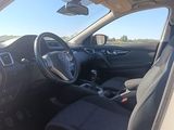 the interior of a white car with black seats and a steering wheel