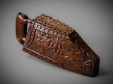 a close up of a wooden object with carvings on it
