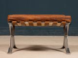 an image of a wooden bench with metal legs and a leather seat