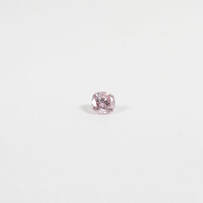 a pink diamond on a white surface
