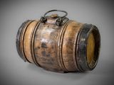 an old wooden barrel with a metal handle on a gray background