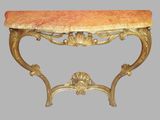 a marble top table with a gold frame and a red marble top