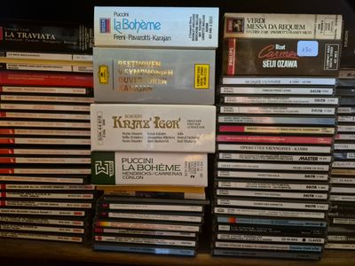 many dvds stacked on top of each other on a shelf