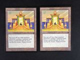 two cards that are on a black table