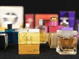 a lot of perfume bottles that are lined up on a table