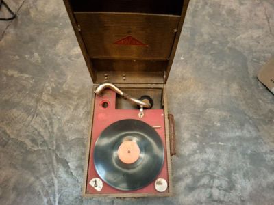 un vieux tourne-disque rangé dans un coffret en bois