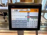 an image of a terminal with a pay machine on the counter
