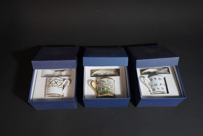 three boxed tea cups in a blue box on a black surface