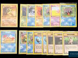 several pokemon cards are lined up on a black surface
