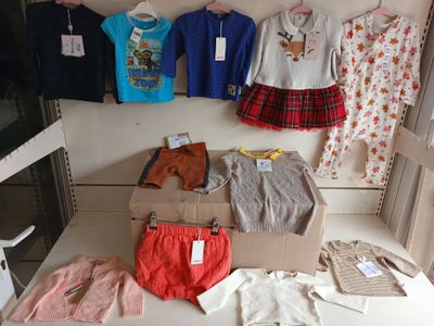 a lot of clothes hanging on a wall in a room