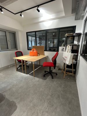 a room with a table, chairs, and a window