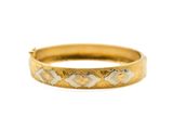 a close up of a gold ring on a white background
