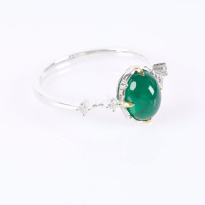 a close up view of a green jade ring on a white background