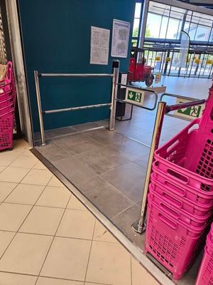 purple baskets are lined up in front of a door in a store