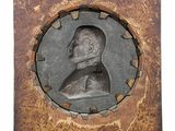 portrait of a man in a wooden frame with a plaque on it