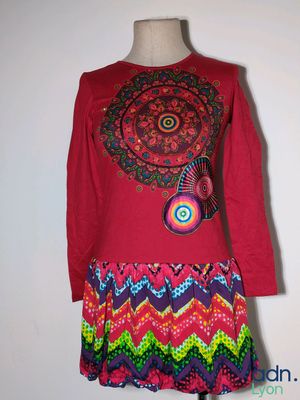 a picture of a colorful dress on a mannequin stand