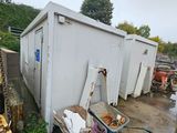 a dumpster that is sitting next to a building