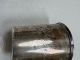 a silver cup that is sitting on a table