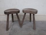 two wooden stools sitting next to each other in a room