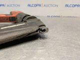 a close up of a stapler on a table with a sign in the background