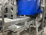 a machine that has a blue bag on the conveyor belt