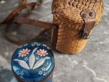 a wicker basket and a blue box on a table
