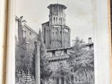 an open book with a picture of a tower in the background