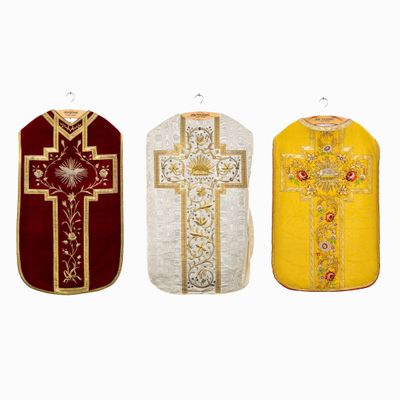 three different colored vests with a cross on them on a white background