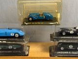 three different models of cars on display in a display case