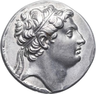 a close up of a silver coin with a woman ' s head on it
